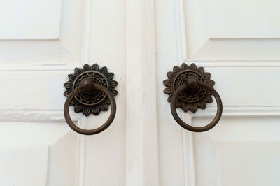 Close-up of doorknob on white door