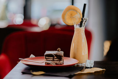 Close-up of juice and pastry on table