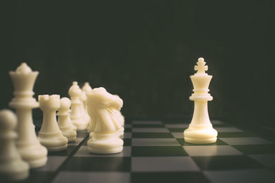 Close-up of chess pieces against black background