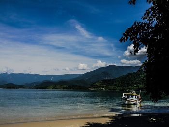 Scenic view of lake against cloudy sky