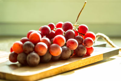 Close-up of red grapes on cutting board