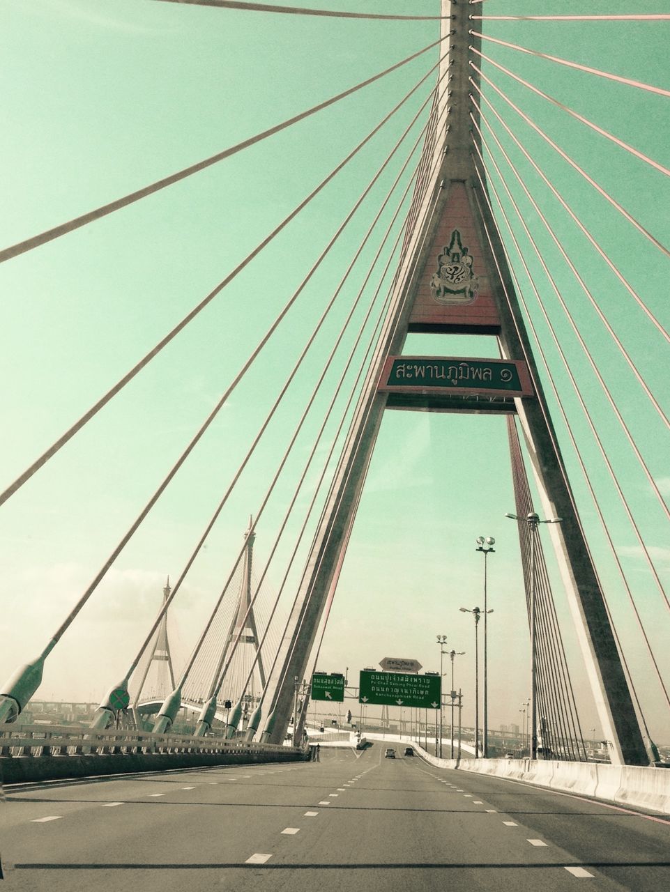 connection, transportation, bridge, built structure, architecture, bridge - man made structure, engineering, sky, road, suspension bridge, direction, the way forward, nature, cable, travel destinations, day, city, travel, sign, outdoors, diminishing perspective, long