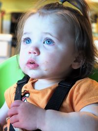 Close-up of cute baby girl with messy mouth at home