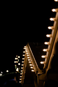 Illuminated lights against sky at night