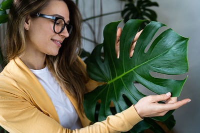 Close-up of woman holding plant at shop