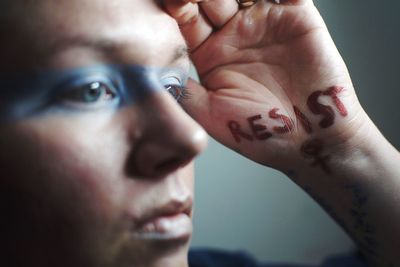 Close-up of young woman with hands