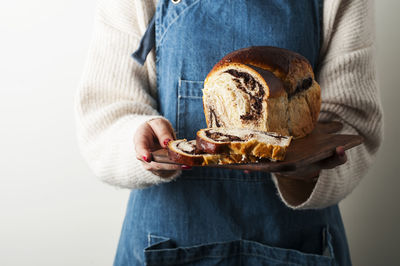 Midsection of woman holding plate with bread