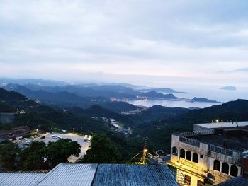 High angle view of city against cloudy sky