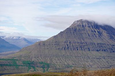 Scenic view of mountains against cloudy sky