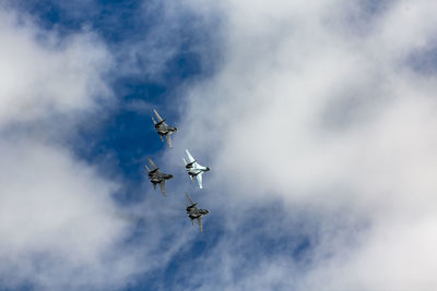 Low angle view of airplane flying against sky