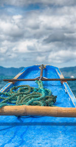 Rope tied to blue sea against sky