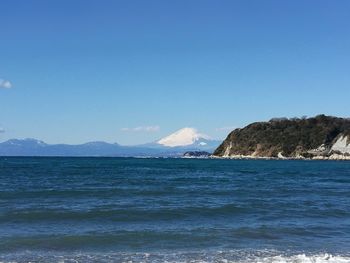 Scenic view of sea against clear blue sky