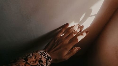 Close-up of woman hand on wall