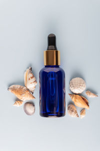 Face serum close-up on the trendy blue background. collagen, hyaluronic acid for skin care. modern 