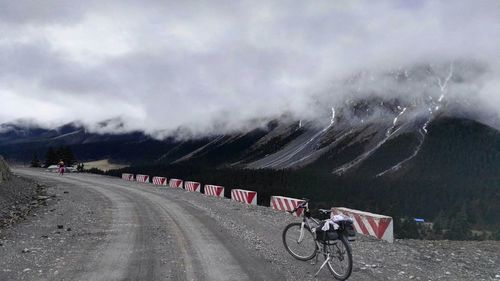 Bicycles on road against mountain range