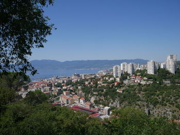 High angle view of buildings against clear blue sky