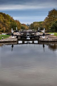 Boats moored in lake against sky