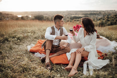 Friends sitting on field