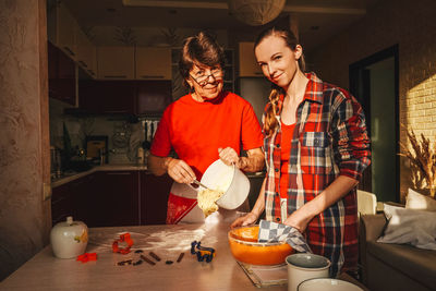 Man and woman standing in kitchen at home