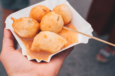 Close-up of hand holding ice cream