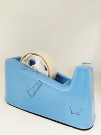 Close-up of machine part against white wall