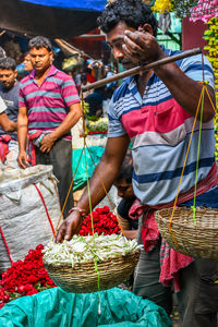 Group of people in basket for sale at market stall