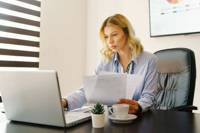 Woman using laptop on table