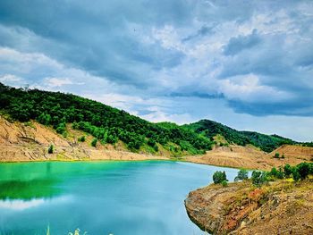 Scenic view of lake and mountains against sky