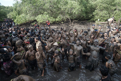 High angle view of people standing by tree