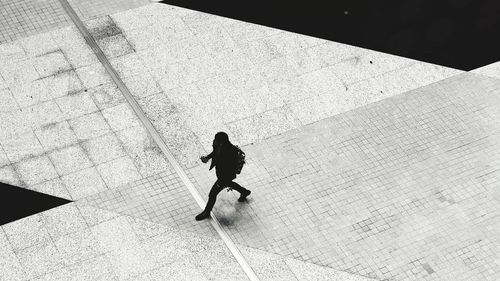 High angle view of woman walking on footpath