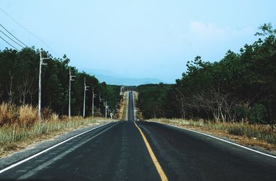 Country road against sky