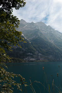 Scenic view of lake and mountains against sky