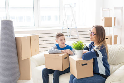 Smiling young woman sitting in box