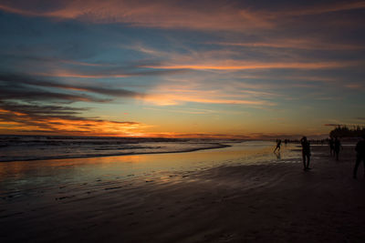 Scenic view of beach against sky during sunset