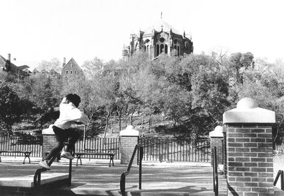 Full length of woman standing on railing