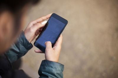 Midsection of man using mobile phone