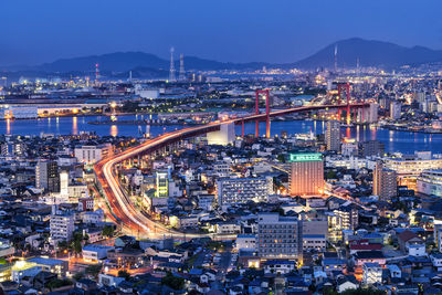 High angle view of illuminated city buildings at night