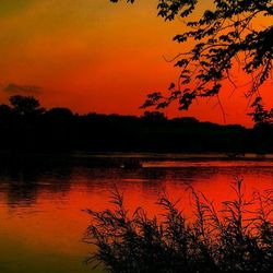 Scenic view of lake against orange sky