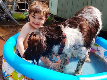 Full length of woman with wet dog