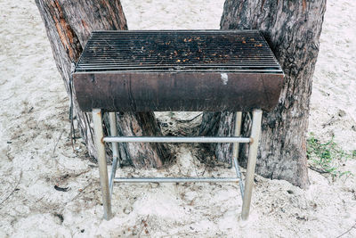 High angle view of old bench on field