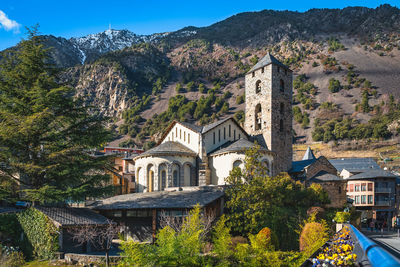 Stone st. esteve church surrounded by green trees, andorra la vella