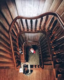 Directly above shot of man and woman standing at spiral staircase