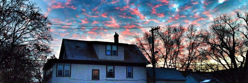 Low angle view of buildings against cloudy sky