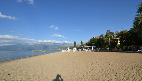 Scenic view of beach against blue sky