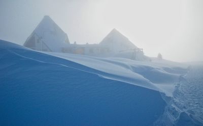 Scenic view of snow covered mountain against clear sky