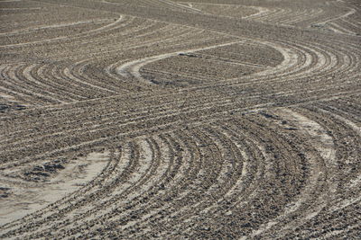 High angle view of tire tracks on land