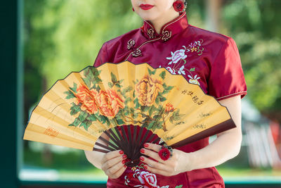 Midsection of woman holding bouquet