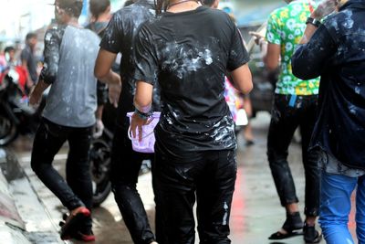 Rear view of people on road during holi