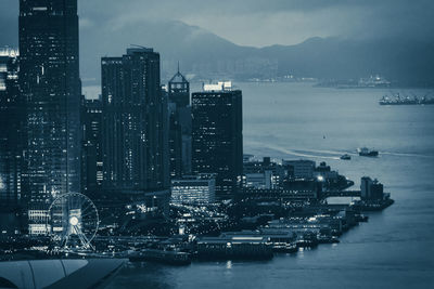 High angle view of cityscape by sea against sky