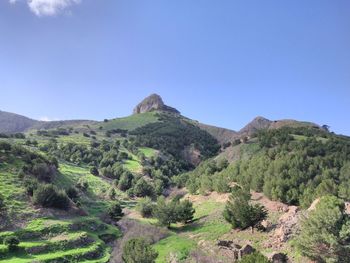 Scenic view of mountains against clear blue sky